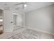 Bright bedroom with a ceiling fan, closet with mirrored doors, and neutral carpeting at 620 Middlebury Loop, New Smyrna Beach, FL 32168