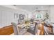 Elegant dining area with a glass table and seating for four, next to an open-concept living space at 620 Middlebury Loop, New Smyrna Beach, FL 32168
