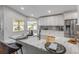 Bright kitchen with white cabinets, stainless steel appliances, and marble countertops at 620 Middlebury Loop, New Smyrna Beach, FL 32168
