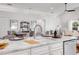 Bright kitchen featuring white cabinetry, stainless steel appliances and eat-in dining at 620 Middlebury Loop, New Smyrna Beach, FL 32168