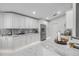 Contemporary kitchen featuring white cabinets, marble countertops, and stainless steel appliances at 620 Middlebury Loop, New Smyrna Beach, FL 32168