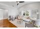Bright open living room with neutral decor, hardwood flooring, ceiling fan and lots of windows at 620 Middlebury Loop, New Smyrna Beach, FL 32168