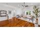 Open living room with wood flooring, white walls, ceiling fan and lots of natural light at 620 Middlebury Loop, New Smyrna Beach, FL 32168