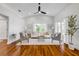 Bright living room with vaulted ceilings, wood floors, and a modern ceiling fan at 620 Middlebury Loop, New Smyrna Beach, FL 32168