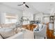 Bright open living room with hardwood flooring, ceiling fan, and neutral décor at 620 Middlebury Loop, New Smyrna Beach, FL 32168