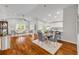 Open concept living and dining area with wood floors, recessed lighting, and large windows at 620 Middlebury Loop, New Smyrna Beach, FL 32168