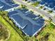 The drone's-eye view displays the unique architecture and landscaping of a home in a quiet community at 6307 Hanfield Dr, Port Orange, FL 32128
