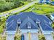 Aerial view of a home featuring a roof with dormers and a paver driveway in a community with green spaces at 6307 Hanfield Dr, Port Orange, FL 32128