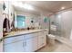 Well-lit bathroom featuring a vanity with stone countertops and a glass-enclosed shower at 6307 Hanfield Dr, Port Orange, FL 32128