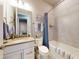 Charming bathroom with vanity, tub-shower combo, and nautical-themed decor, creating a relaxing and inviting space at 6307 Hanfield Dr, Port Orange, FL 32128