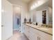 Bathroom featuring a double vanity, granite countertops, and tile flooring, and an open doorway to the closet at 6307 Hanfield Dr, Port Orange, FL 32128