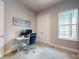 Bedroom with Murphy bed, desk, neutral color palette, and great natural light, a perfect space for relaxation or productivity at 6307 Hanfield Dr, Port Orange, FL 32128