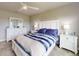 Bright bedroom with a white bed frame, blue and white bedding, dresser with mirror and night stands at 6307 Hanfield Dr, Port Orange, FL 32128