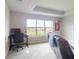 Comfortable bedroom featuring a large window with scenic views and a cozy seating area at 6307 Hanfield Dr, Port Orange, FL 32128