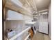 Walk-in closet with custom white shelving, drawers and organizers at 6307 Hanfield Dr, Port Orange, FL 32128