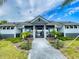 Welcoming clubhouse entrance set amidst lush landscaping, perfect for community gatherings and events at 6307 Hanfield Dr, Port Orange, FL 32128