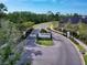 The Spruce Meadow community entrance is marked by a prominent sign along a winding road amidst lush landscaping at 6307 Hanfield Dr, Port Orange, FL 32128