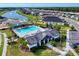 Aerial view of a neighborhood pool and clubhouse surrounded by lush landscaping in a residential community at 6307 Hanfield Dr, Port Orange, FL 32128