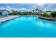 Enjoy the community pool surrounded by comfortable lounge chairs and swaying palm trees at 6307 Hanfield Dr, Port Orange, FL 32128