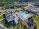 An aerial view shows the community pool, playground and clubhouse are surrounded by lush green landscaping and lawns at 6307 Hanfield Dr, Port Orange, FL 32128