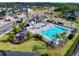 A community pool and playground sit next to a clubhouse in a residential neighborhood with paved roads at 6307 Hanfield Dr, Port Orange, FL 32128