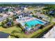 Community amenities featuring a pool, clubhouse, playground, and manicured lawns in a residential neighborhood at 6307 Hanfield Dr, Port Orange, FL 32128