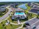 Aerial view showcases the community pool and splash pad, along with neighborhood homes and landscaping at 6307 Hanfield Dr, Port Orange, FL 32128