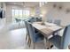 Dining area with modern light fixture, large windows, and comfortable seating at 6307 Hanfield Dr, Port Orange, FL 32128