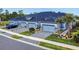 A row of new townhomes, each featuring a two-car garage, manicured landscaping and brick paved driveways at 6307 Hanfield Dr, Port Orange, FL 32128