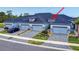 Charming townhome showcases a well-maintained exterior with stone accents, grey paint, and a landscaped front yard at 6307 Hanfield Dr, Port Orange, FL 32128