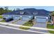 A row of new townhomes, each featuring a two-car garage, manicured landscaping and brick paved driveways at 6307 Hanfield Dr, Port Orange, FL 32128