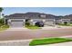 Beautiful townhome showcasing a three-car garage and manicured lawn, perfect for low-maintenance living at 6307 Hanfield Dr, Port Orange, FL 32128