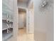 Light filled hallway with decorative touches, leading to the home's interior, and showcasing the neutral color palette at 6307 Hanfield Dr, Port Orange, FL 32128