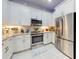Bright kitchen features white cabinetry, stainless steel appliances, and a decorative tile backsplash at 6307 Hanfield Dr, Port Orange, FL 32128