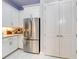 Bright kitchen boasts white cabinets, stainless steel appliances, and pantry storage at 6307 Hanfield Dr, Port Orange, FL 32128