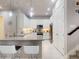 Bright kitchen features white cabinetry, stainless steel appliances, a tile backsplash, pendant lighting, and a spacious island at 6307 Hanfield Dr, Port Orange, FL 32128