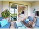 Relaxing lanai with stylish seating, lush greenery, and access to the home's elegant living space at 6307 Hanfield Dr, Port Orange, FL 32128