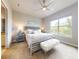 Bright main bedroom featuring a ceiling fan, a king bed, and a large window with lots of light at 6307 Hanfield Dr, Port Orange, FL 32128