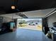 View through open garage screen to the neighborhood and home's paved driveway at 6307 Hanfield Dr, Port Orange, FL 32128