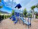 Community playground features blue climbing structures and slides on a bed of wood chips at 6307 Hanfield Dr, Port Orange, FL 32128