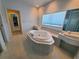 Bright bathroom features a jetted tub, double sinks, and large windows for natural light at 6340 Engram Rd, New Smyrna Beach, FL 32169