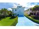 Two story white home with blue driveway and lawn at 6340 Engram Rd, New Smyrna Beach, FL 32169