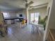 Bright kitchen with white cabinets, an island, and a dining area at 6340 Engram Rd, New Smyrna Beach, FL 32169