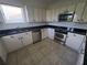 Kitchen features white cabinets, stainless steel appliances at 6340 Engram Rd, New Smyrna Beach, FL 32169