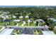 Aerial view of house with a long driveway and lush green lawn, outlined in yellow at 653 Goodwin Ave, New Smyrna Beach, FL 32169