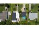 Aerial view of light blue home with a dark shingle roof, showcasing the layout of the yard and surrounding area at 653 Goodwin Ave, New Smyrna Beach, FL 32169