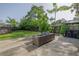 Backyard featuring lounge seating and outdoor kitchen area, all surrounded by lush greenery at 653 Goodwin Ave, New Smyrna Beach, FL 32169