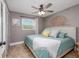 Comfortable bedroom with warm lighting, decor and a decorative ceiling fan at 653 Goodwin Ave, New Smyrna Beach, FL 32169