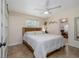Bright bedroom features a ceiling fan, tiled floor, a closet, and a large window at 653 Goodwin Ave, New Smyrna Beach, FL 32169