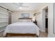 Bright bedroom features a ceiling fan, tiled floor, a closet, and a large window at 653 Goodwin Ave, New Smyrna Beach, FL 32169